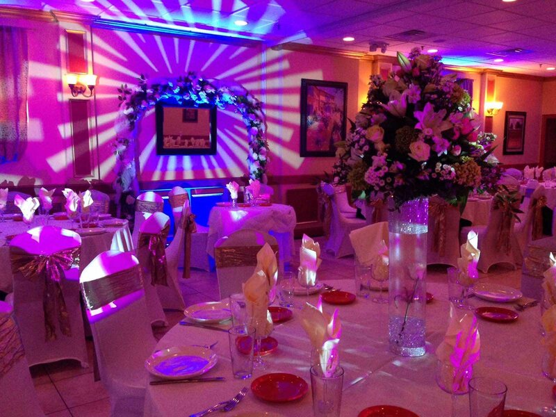 Duomo room with purple ambient lightning and a projection near on a wedding arch