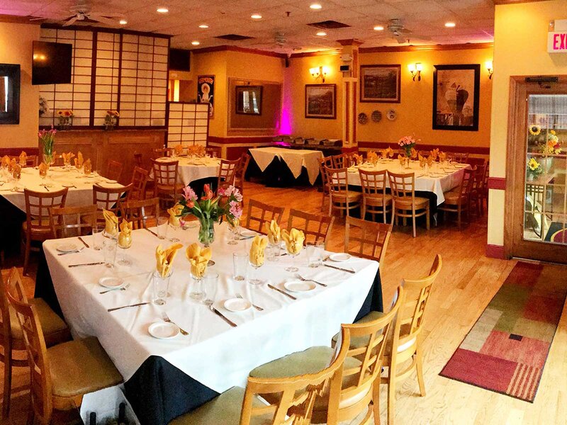Scala room with tables set for guests with white table cloths and gold napkins