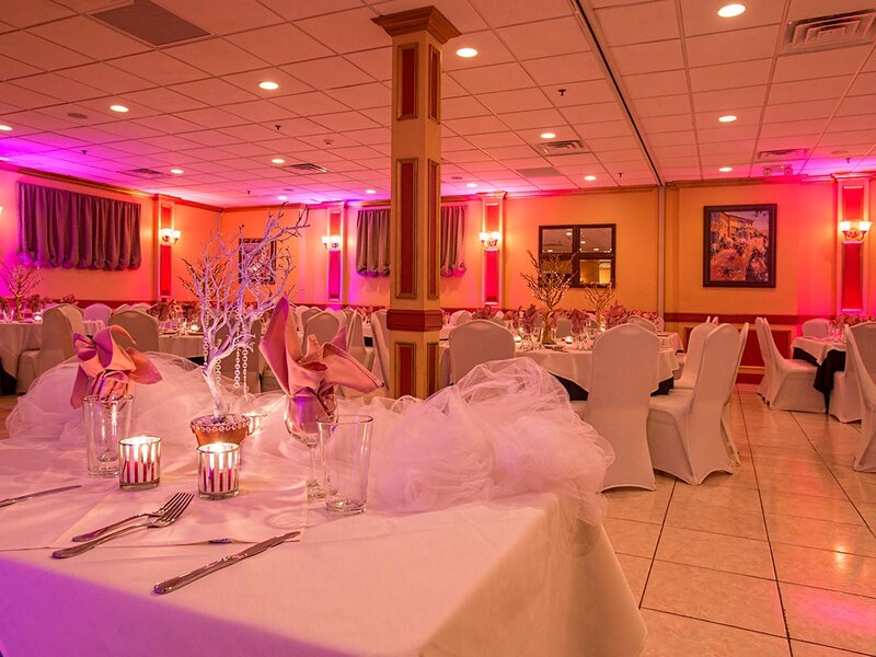 Duomo room with set tables and purple and fuchsia ambient lighting