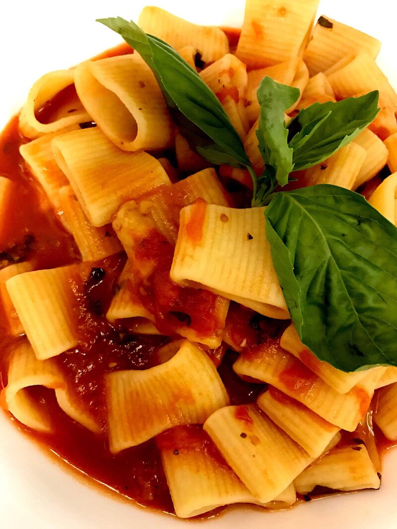Rigatoni pasta topped with basil