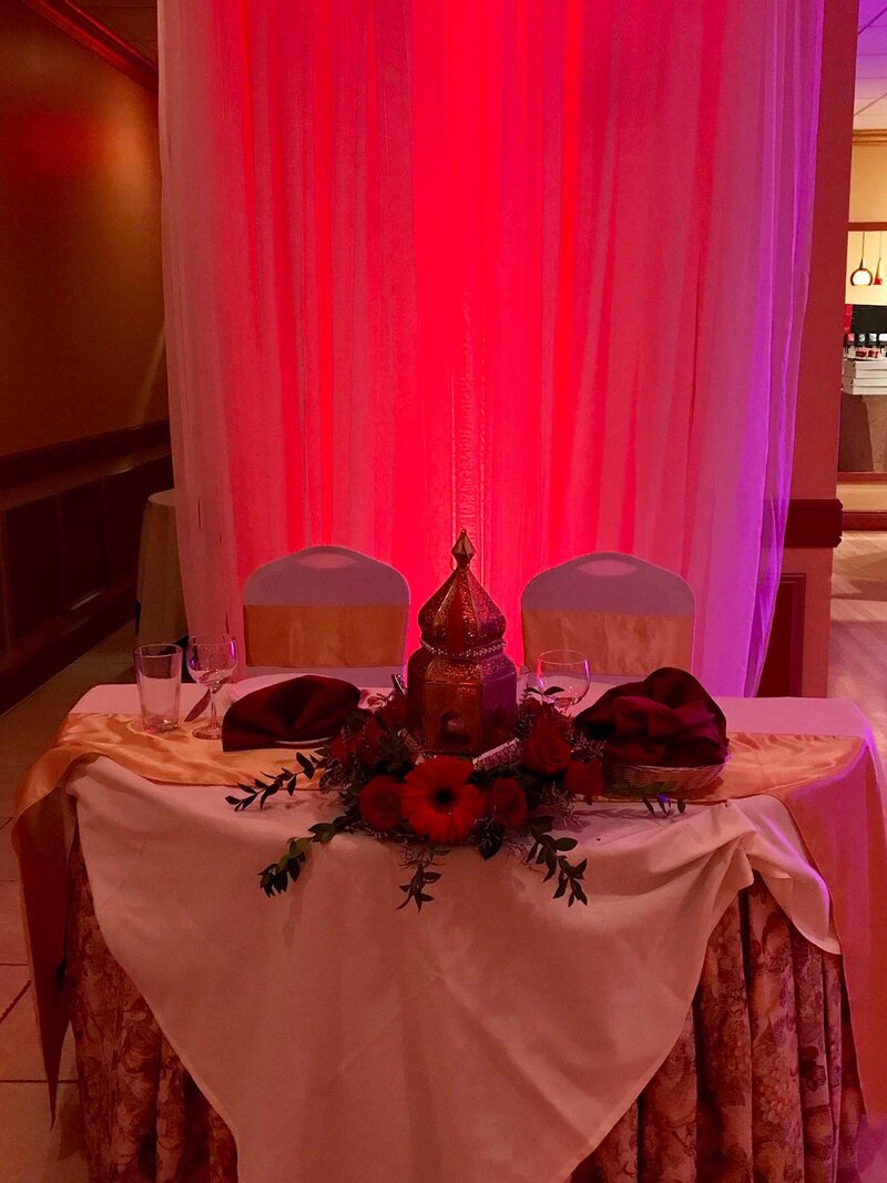 Table for two decorated with different linens and flowers